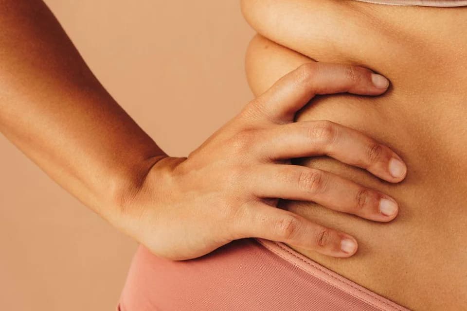 A body detail with a hand resting on the hip