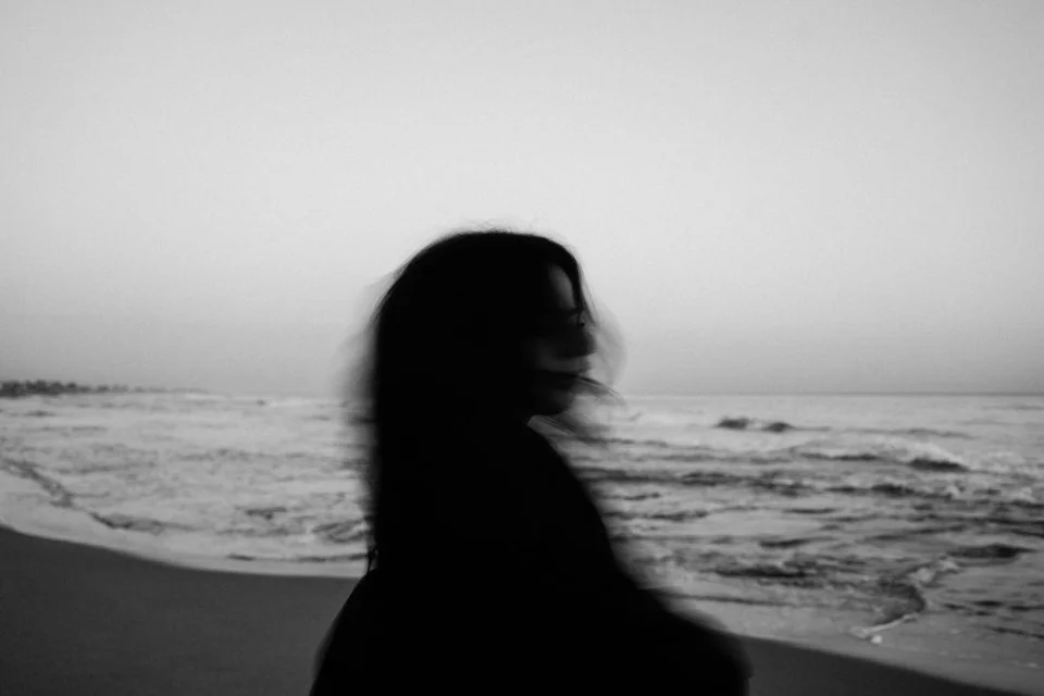 An anonymous woman seen from behind by the sea