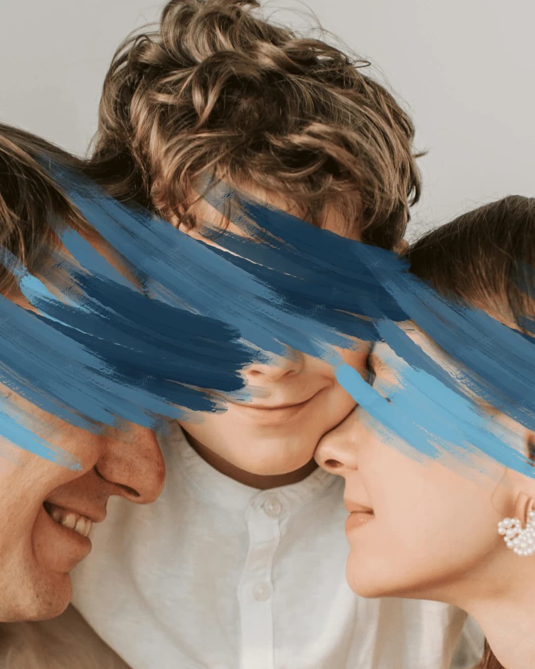 A boy between two adults, with blue brushstrokes across their eyes