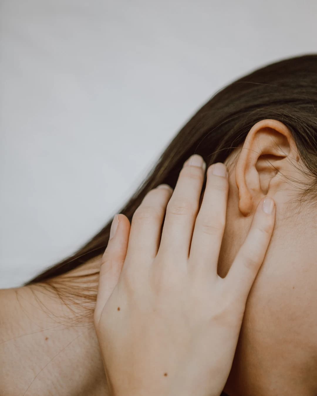 A hand beside an ear